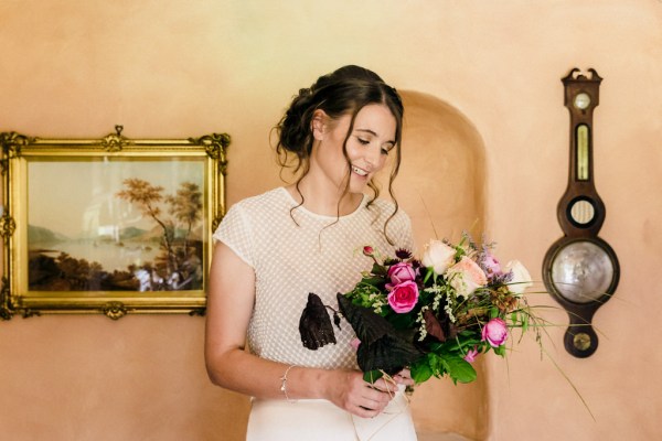 bride looking at bouquet flowers