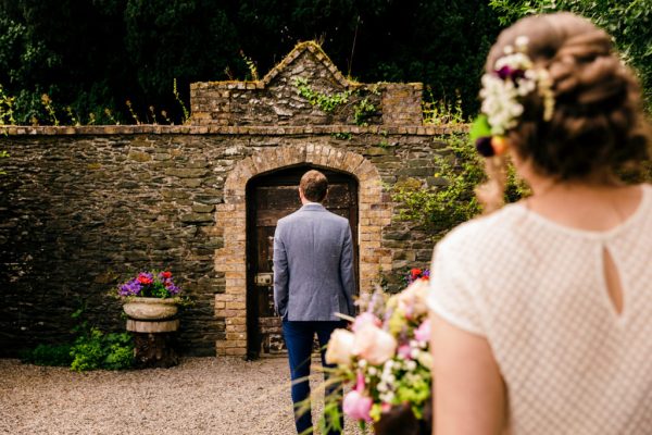 groom awaits his bride in garden hair detail accessories