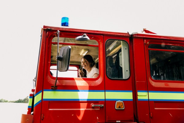 firetruck with bride in passenger seat arrives