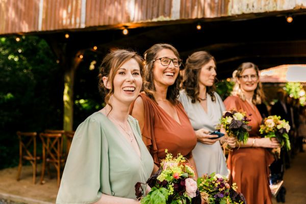 bridesmaids await the bride smiling