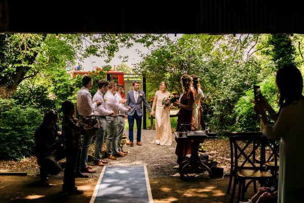 father of the bride walks his daughter into wedding venue