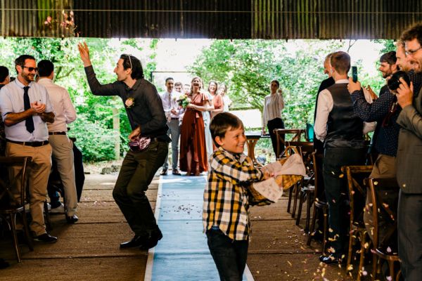 guest in front of audience joking around confetti and little boy in shot