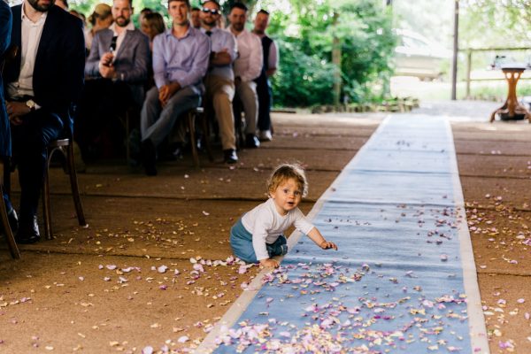 little boy plays on the ground close to aisle