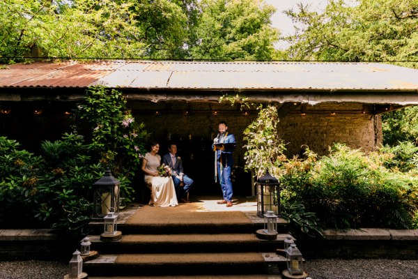 wide shot of bride and groom at alter setting guests seated