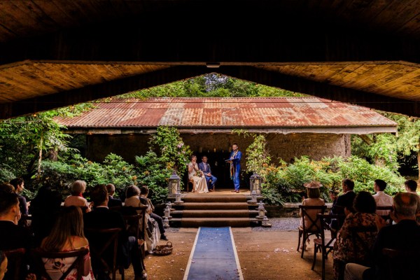 wide shot of bride and groom at alter setting guests seated