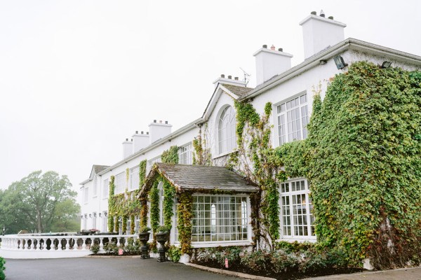 exterior wedding venue entrance covered in ivory/ivy