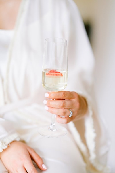 bride holds champagne prosecco glass cocktail