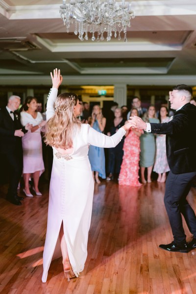 bride and groom on the dancefloor surrounded by guests