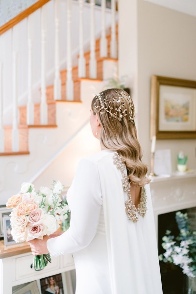 detail of back of brides hair wavy blonde hair accessory and bouquet