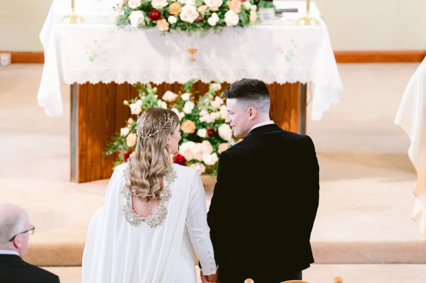 bride and groom at the alter from behind