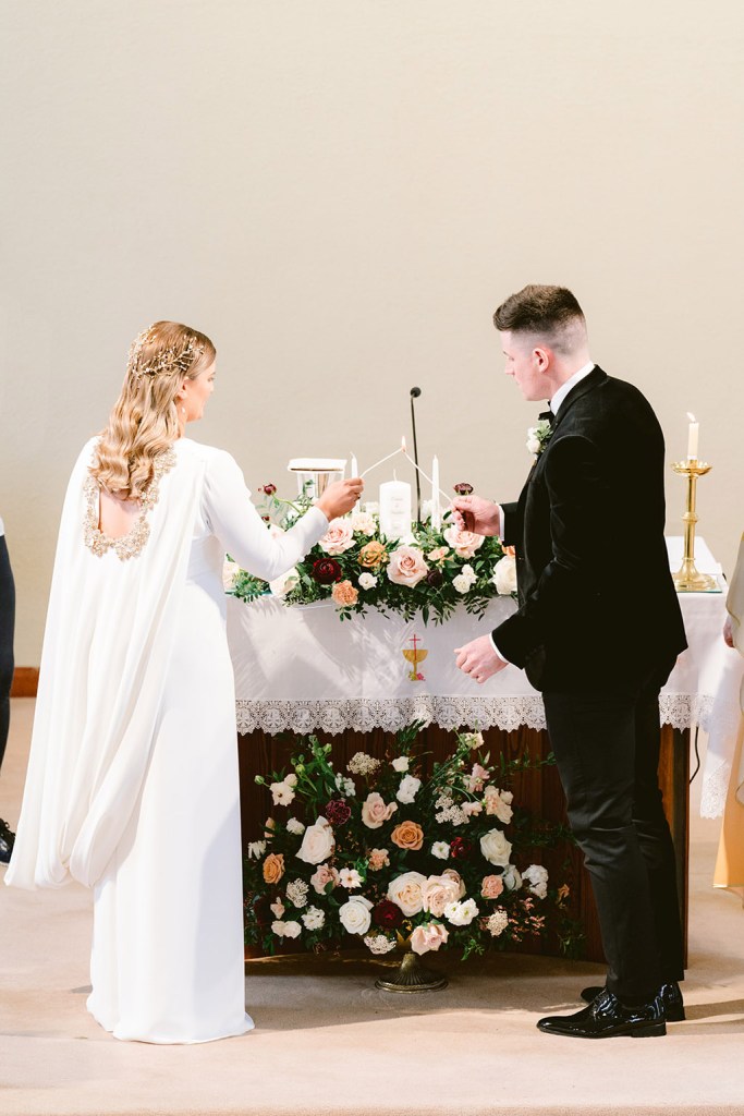 bride and groom light candles together