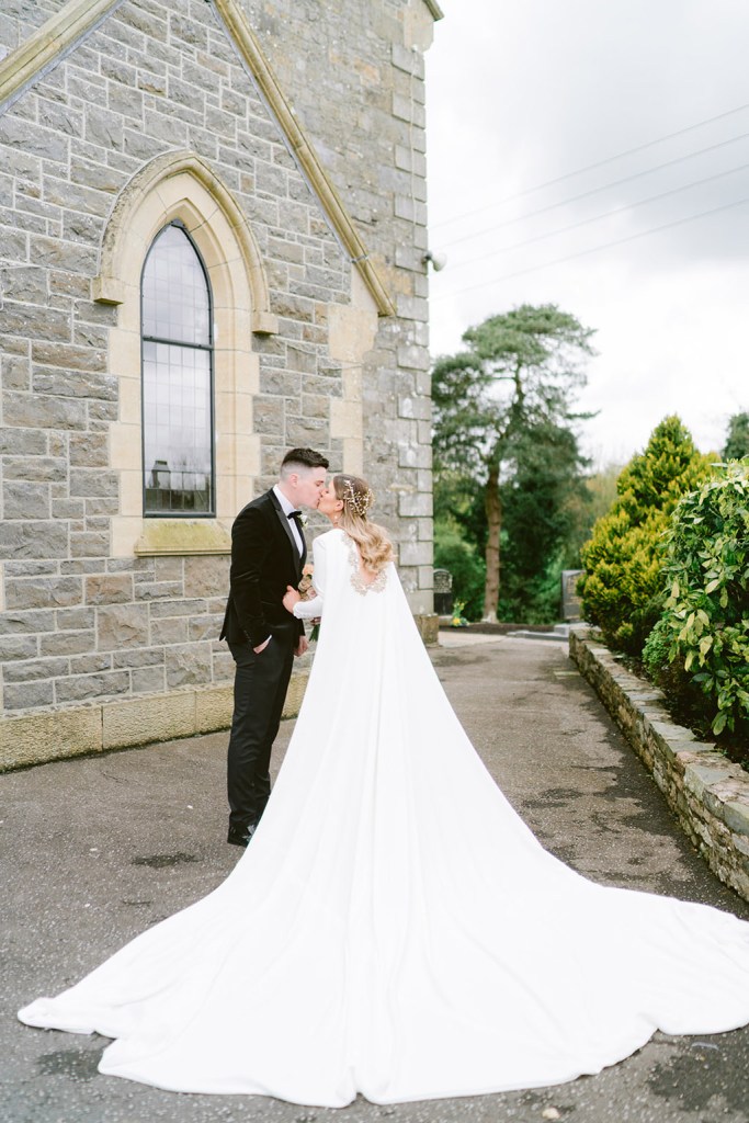 bride and groom in the courtyard to chapel church