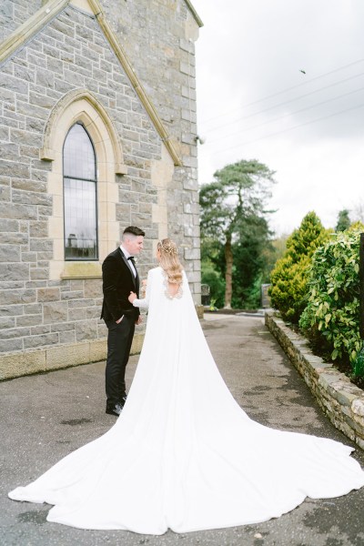 bride and groom in the courtyard to chapel church