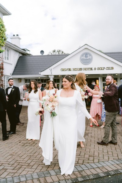 bride bridesmaids and guests outside of wedding venue