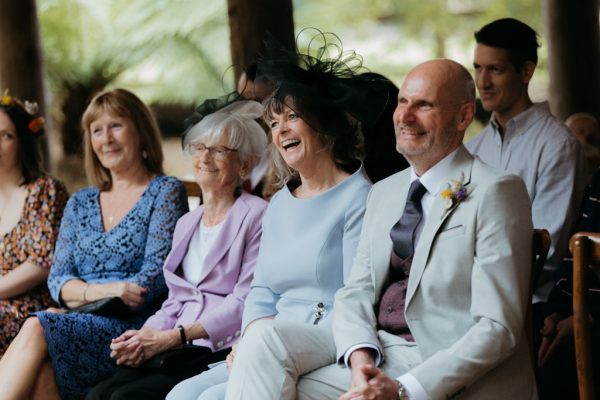 mother and father laugh in audience