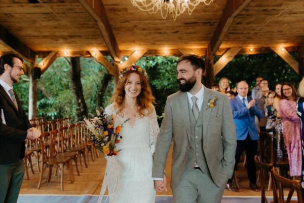 bride and groom exit ceremony setting guests clapping