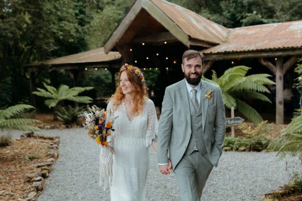 bride and groom walk the pathway outside wedding ceremony