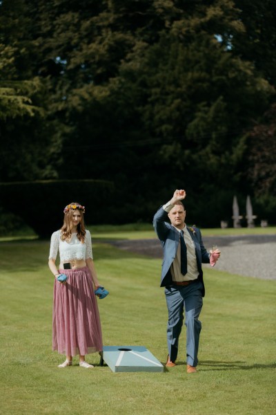 guests outside playing games enjoying the sun on the grass