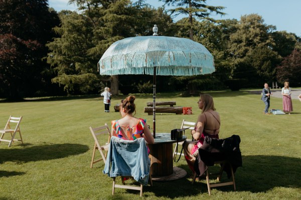 atmosphere shot guests seated under umbrella