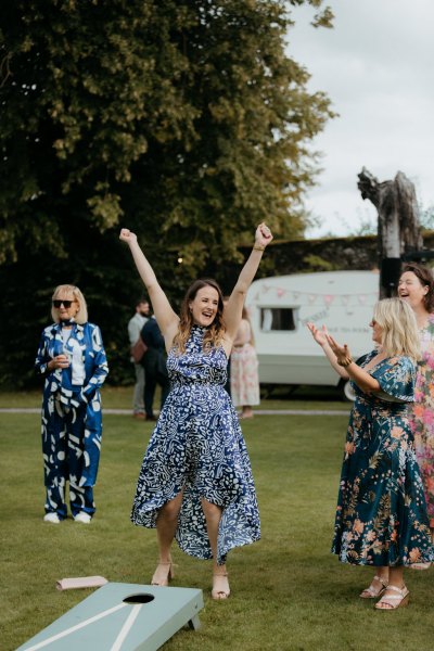 guests celebrate mess around with games on grass outside