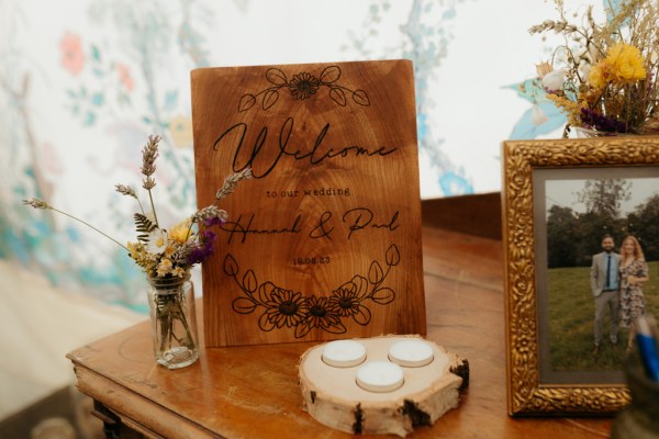 flowers in a vase welcome to the wedding of and tea lights candles