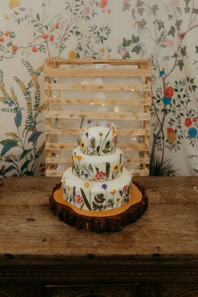 white wedding cake covered in flowers