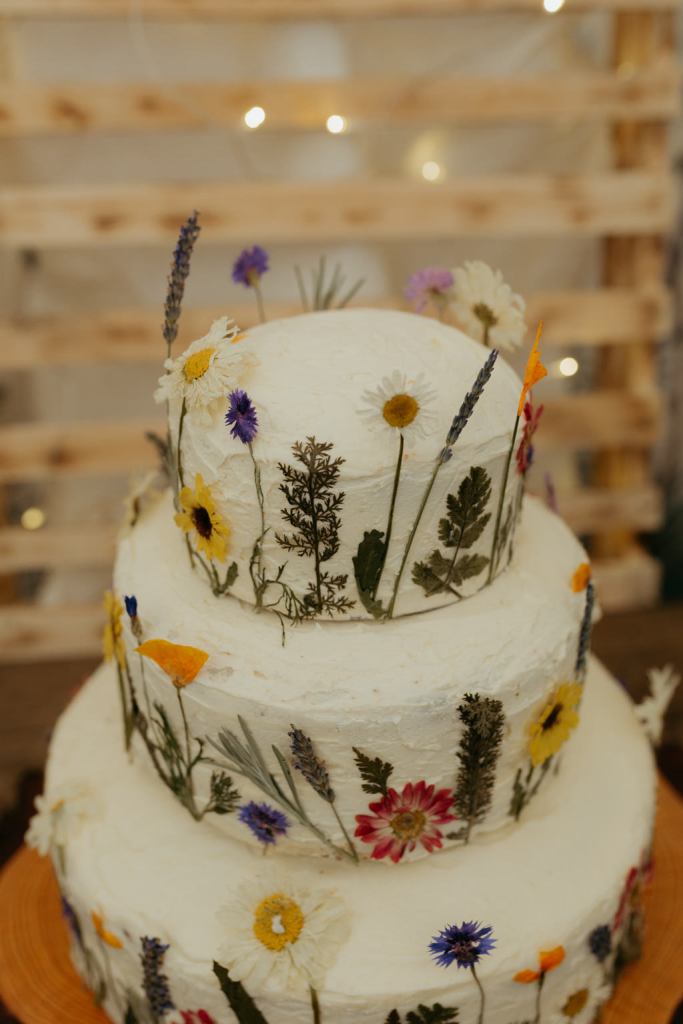 white wedding cake covered in flowers