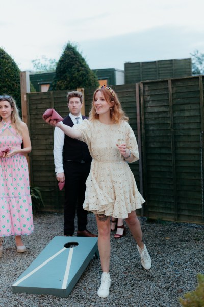 bride playing game outside with guests