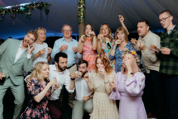 friends bride groom react taking shots portrait