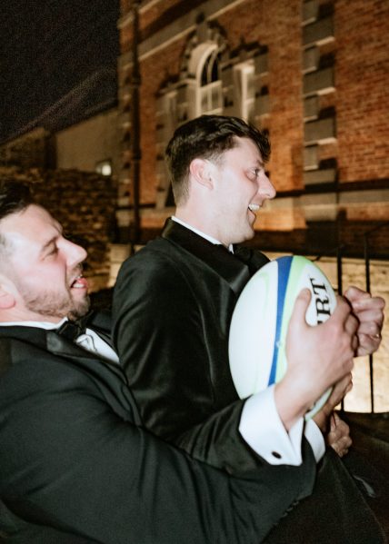 rugby ball groom groomsmen playing around