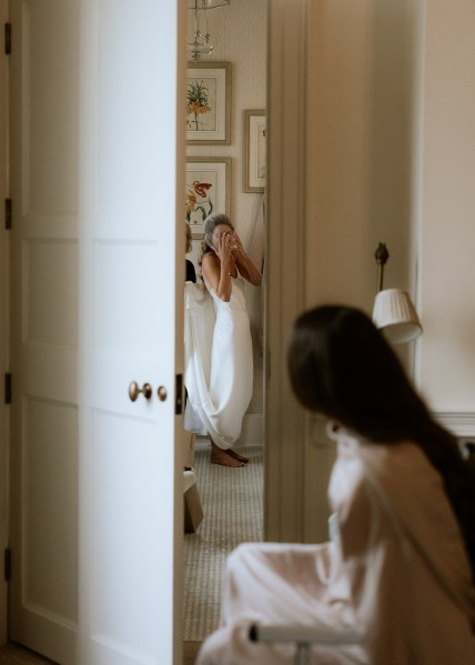 bride enters room where bridesmaids are waiting