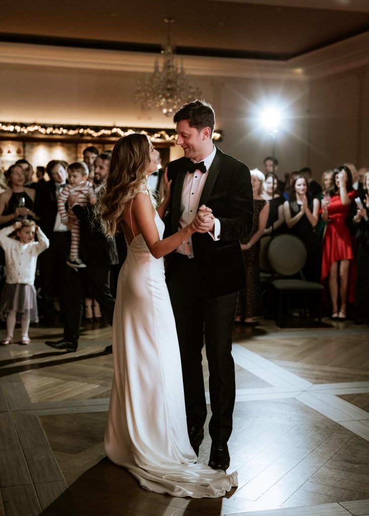 bride and groom enjoy first dance on dancefloor