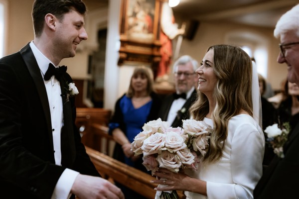 bride and groom at the alter surrounded by guests