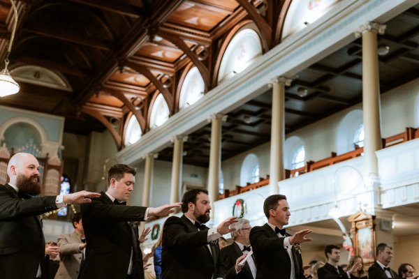 groom and groomsmen waiting at the alter for bride