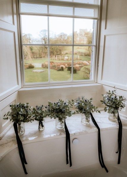 black ribbon hair accessories flowers floral resting beside window