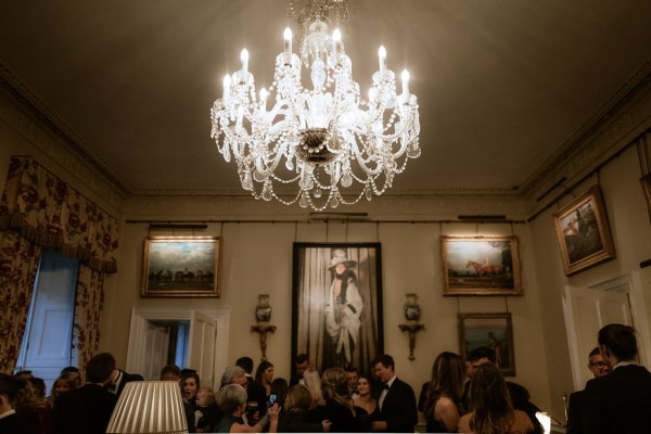 chandelier above guests as they chat