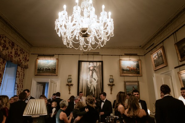 chandelier above guests as they chat