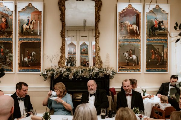 father mother sitting at the ballroom dining room table