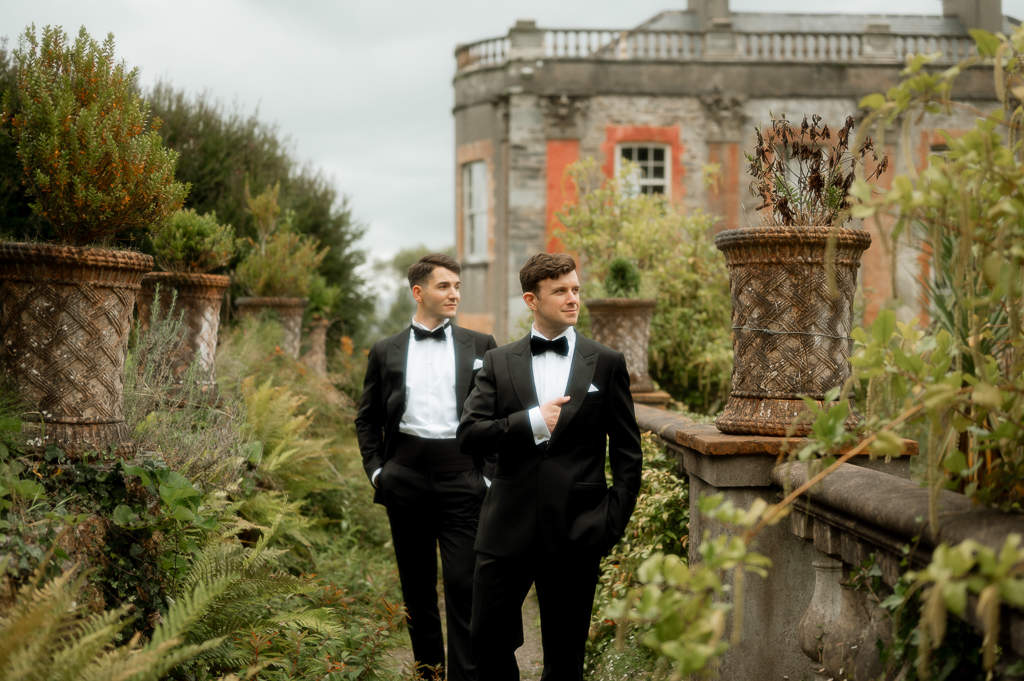 grooms walk amongst the garden together