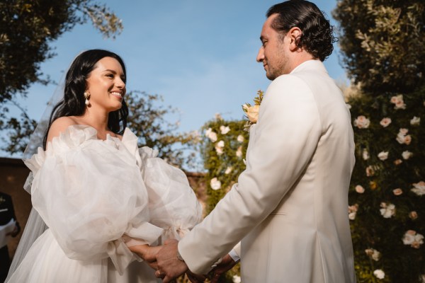 bride and groom hold hands