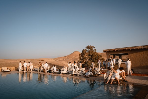 pool lake guests surrounding it in desert