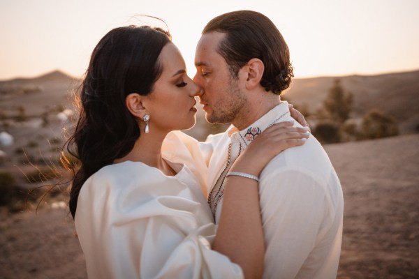 bride and groom go in for a kiss