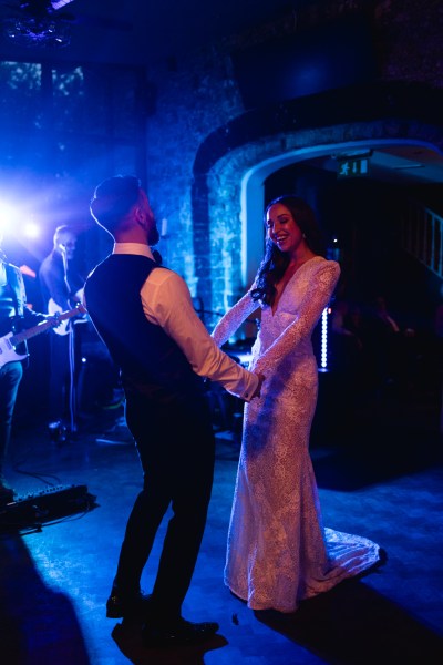 dark shot of bride and groom dancing on the dancefloor