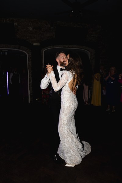 dark shot of bride and groom dancing on the dancefloor