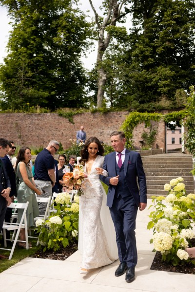 father of the bride walks his daughter down the aisle