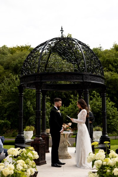 bride reads her vows to groom and audience