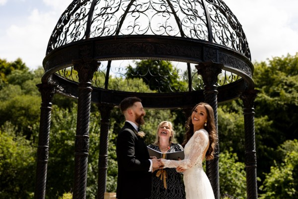 bride groom hut in background celebrant giving speech