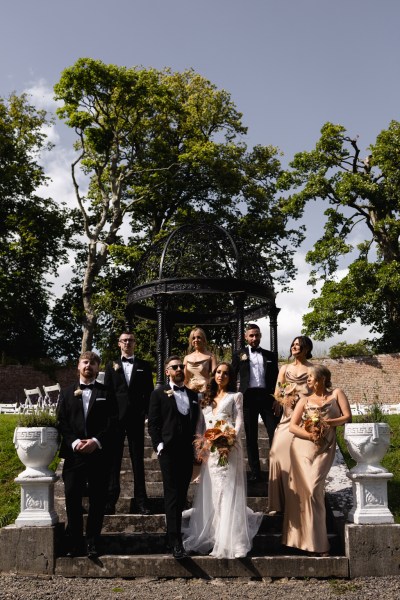 bride groom bridesmaids groomsmen pose for a photo