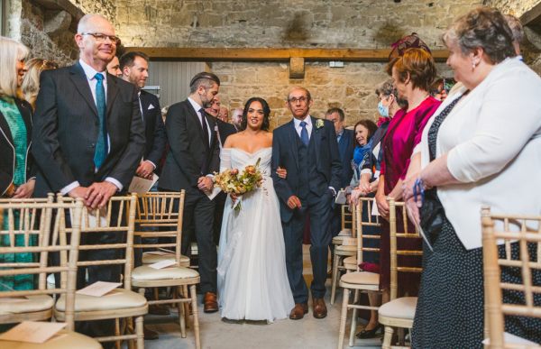 father of the bride walks his daughter down the aisle