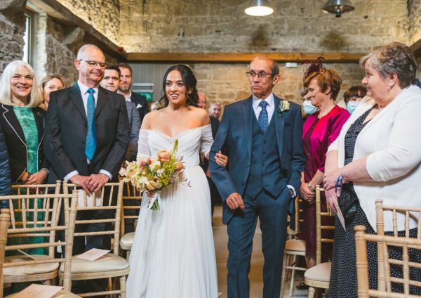 father of the bride walks his daughter down the aisle